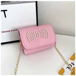 Detail of pink mini bag for girls featuring a pearl bow design and golden chain strap