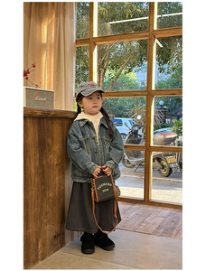 Detailed view of stylish children's crossbody bag styled with trendy denim jacket outfit