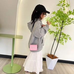 Pink girl's mini crossbody bag with pearl bow decoration and golden chain strap