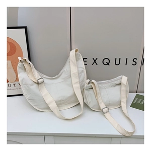 Comparison of large and small beige nylon half-moon crossbody bags with adjustable straps