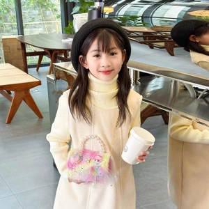 Girl carrying a colorful faux fur mini princess bag with pearl handle and gold chain