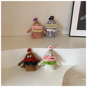 Detail showing knit stitch texture of handmade crochet monster bags in multiple colors