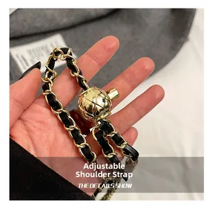 Detail showing the gold chain strap with adjustable diamond pattern metal ball buckle
