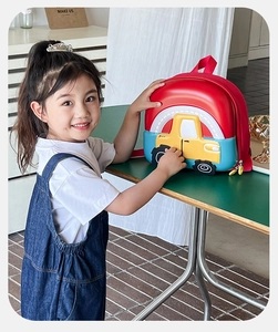 Detail of colorful hard shell kids car backpack featuring 3D embossed rainbow design