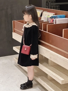 Girl in black velvet dress with lace collar and red quilted chain box bag detail