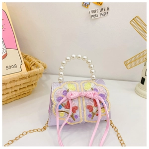 Détails de broderie florale, nœud chinois et poignée en perles sur sac pour enfant