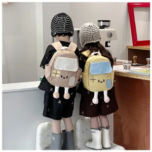 Close-up of cute cartoon house kids backpack with pom-poms and wave stitching detail