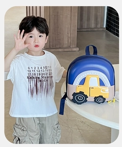 Close-up of a blue 3D excavator hardshell backpack for kids with a yellow tractor design
