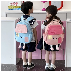 Detailed view of cute house-shaped kids backpacks with 3D legs in pink and blue colors