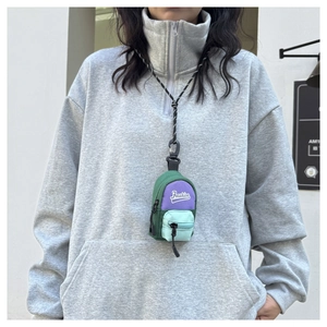 Detailed view of mini neck bag with fashion text and colorful patchwork design