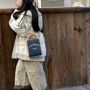 Kids navy blue square crossbody bag with brown handles and gold letter decoration