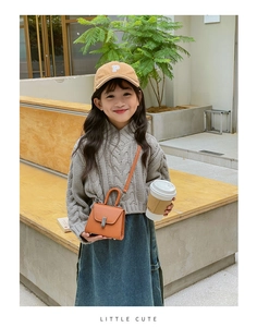 Kids orange leather mini crossbody bag paired with knit sweater and denim skirt outfit