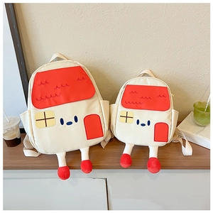Detailed view of 3D stuffed legs with red shoes on a house-shaped toddler backpack