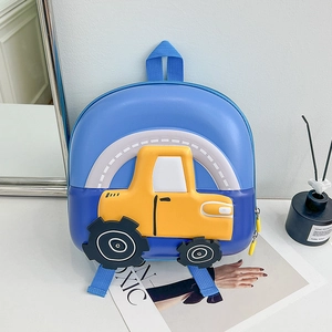Detailed side view of 3D yellow truck shell on blue kids hard shell school backpack
