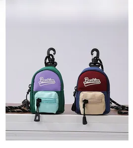 Detailed view of mini canvas pouch pendants with fashion embroidery and plastic hooks