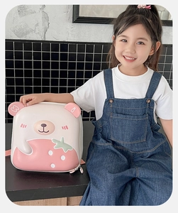 Close-up of pink hardshell backpack featuring 3D strawberry bear ears and cute pattern