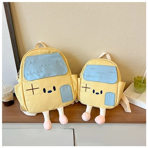 Detail view of cute house-shaped backpacks in two sizes with plush legs and window patterns