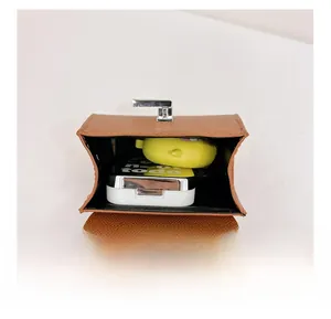 Internal view of brown litchi grain mini shoulder bag showing storage capacity