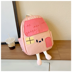 Side view of cute pink house-shaped backpack with soft embroidered windows and plush legs