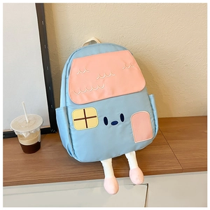 Close-up of a house-shaped kids backpack featuring plush legs and cartoon embroidery