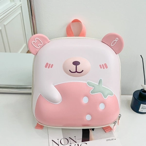 Close-up of pink 3D bear backpack with strawberry print and durable EVA hard shell