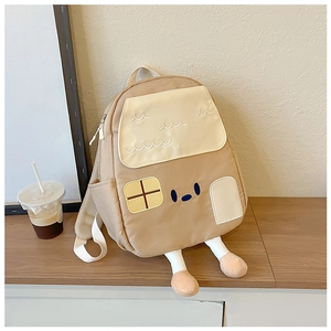 Close-up of cute 3D house-shaped backpack with embroidery and dangling leg details