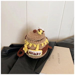 Texture détaillée d'un sac au crochet en forme de pot de miel avec décor d'abeille