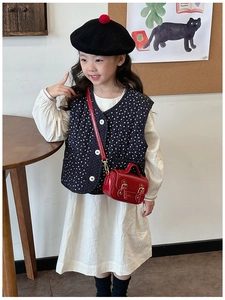 Retro red oil wax leather handbag styled with floral vest and dress for kids