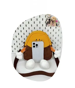 Detailed view of cartoon potato plush crossbody bag compared with a smartphone for size