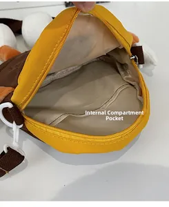 Detail view of the plush cartoon crossbody bag interior with zipper and inner pocket