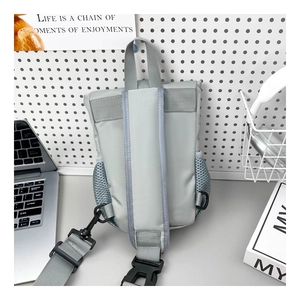 Close-up of gray kids sling bag with breathable mesh straps and durable plastic buckles