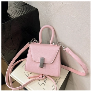 Detailed macro view of pink Saffiano leather texture and silver metal clasp on mini bag