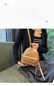 Deep beige faux leather mini backpack featuring front zip pocket and stylish logo detail