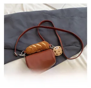 Détails du sac baril en cuir marron avec décor baguette en peluche et porte-clé biscuit