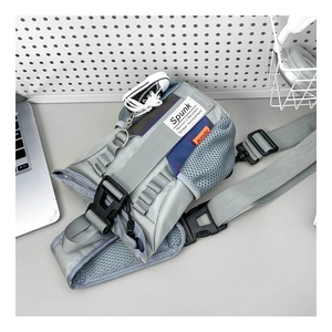 Detailed view of grey nylon kids chest bag with adjustable strap and side mesh pocket