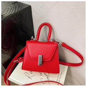 Red mini crossbody bag for kids with textured leather finish and silver metal buckle