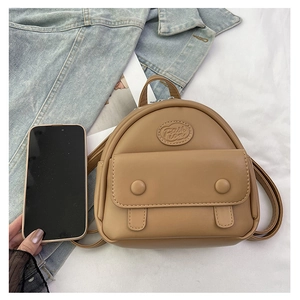 Mini yellow PU leather backpack with Fashion embossing shown next to a smartphone