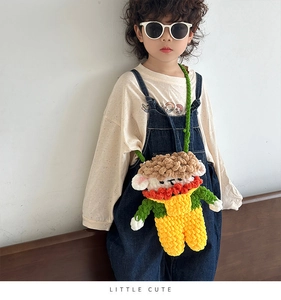 Detail showing hand-knitted sheep crossbody bag with bright yellow crochet doll design