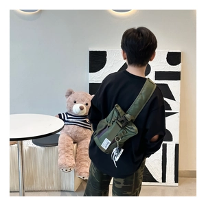 Army green nylon kids crossbody bag with black buckle and sneaker pendant detail
