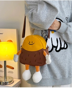 Detail of cute cartoon crossbody bag with 3D plush limbs and adjustable brown strap