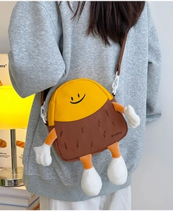 Detail view of cartoon chestnut crossbody bag with yellow and brown patchwork design