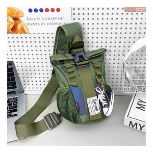 Detail of army green tactical kids sling bag with decorative mini sneaker keychain charm