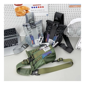 Detailed view of tactical chest bags in grey black and green with decorative mini sneaker