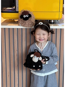 Detailed knit texture of cute sheep crochet crossbody bag with pearl charms for kids
