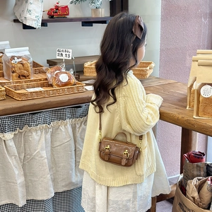 Vintage brown oil-wax leather mini handbag for girls in a cozy bakery setting