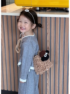 Detail of cute knitted sheep crossbody bag for kids with fuzzy texture and pearl button