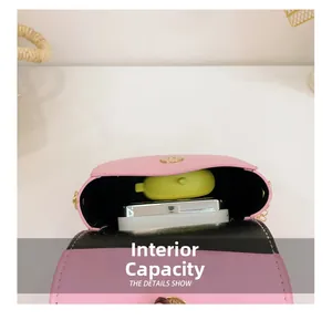 Detail showing the internal storage capacity of the pink girl's chain crossbody bag