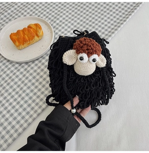 Detailed view of handmade crochet sheep crossbody bag with drawstring and pearl detail