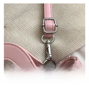 Detail of silver metal hook and adjustable strap on pink quilted leather bag for kids