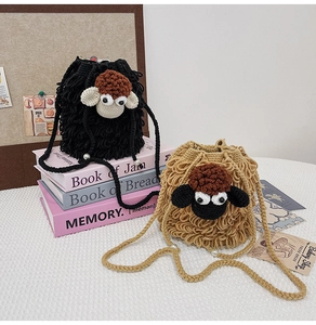 Detail of hand-crocheted sheep bags with wool texture, pearl accents and cute 3D ears